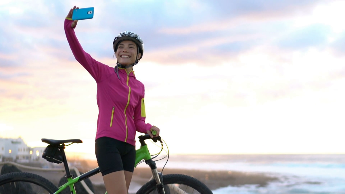 happy-young-female-cyclist-taking-selfie-using-smart-phone-while-mtb-mountain-biking-beautiful-woman-in-sportswear-is-posing-with-bicycle-she-is-photographing-using-smart-phone-in-nature-with-bike_stmwuq5kzx_thumbnail-ful.png